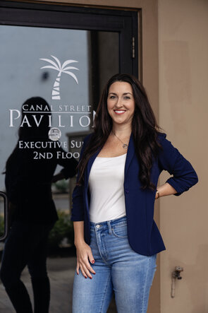 Photo of Britney Beck Photo of Britney Beck of Hi-Wire HR Consulting, standing in front of office door